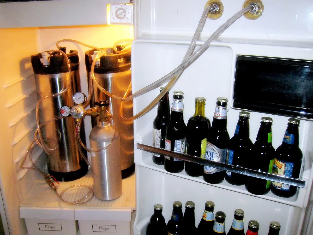 Home refrigerator converted into a kegerator with a Cornelius keg inside
