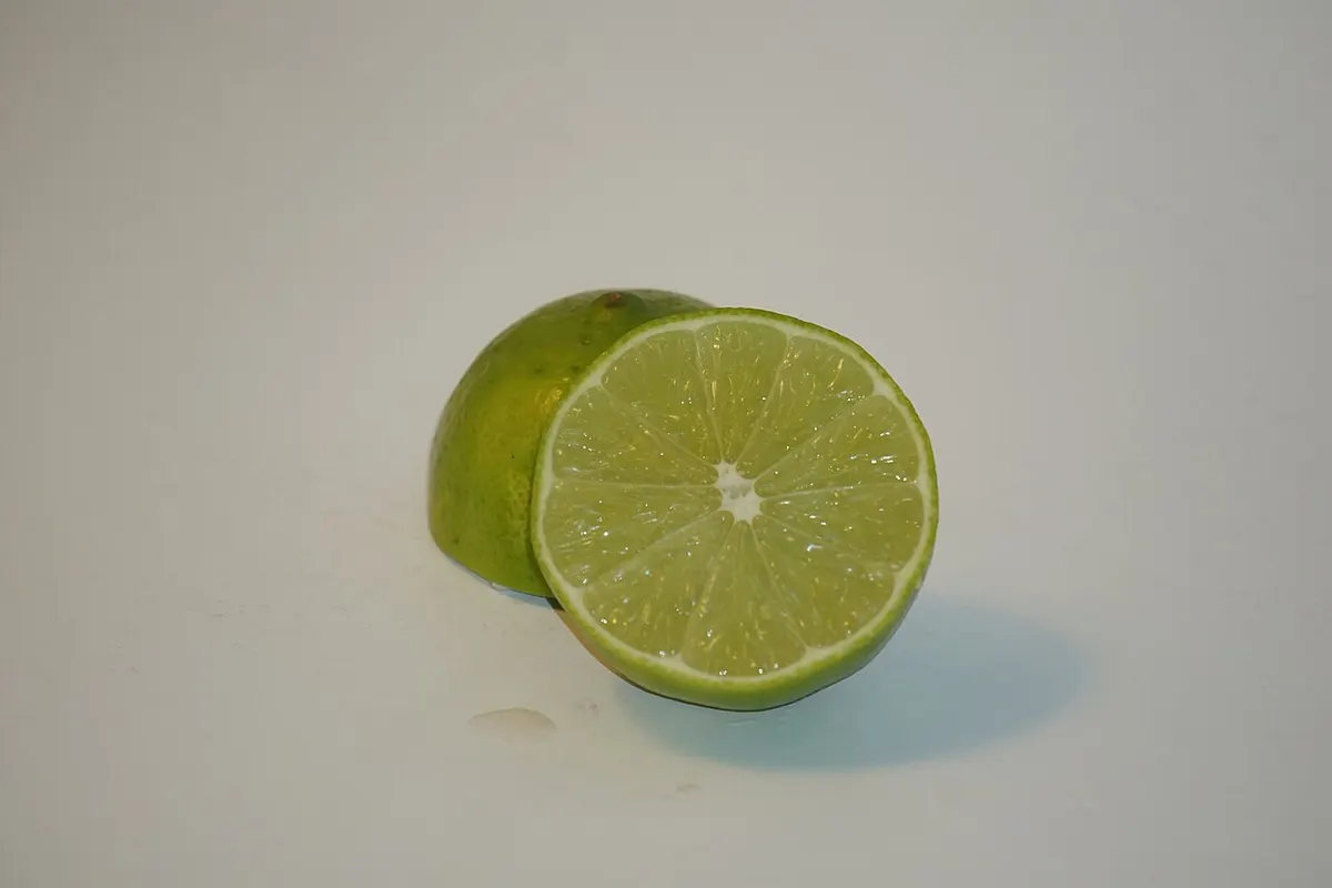 Fresh limes being juiced for a cocktail