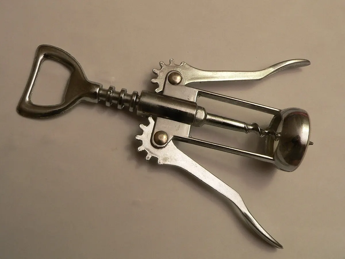A waiter's-key double-hinged corkscrew opening a wine bottle